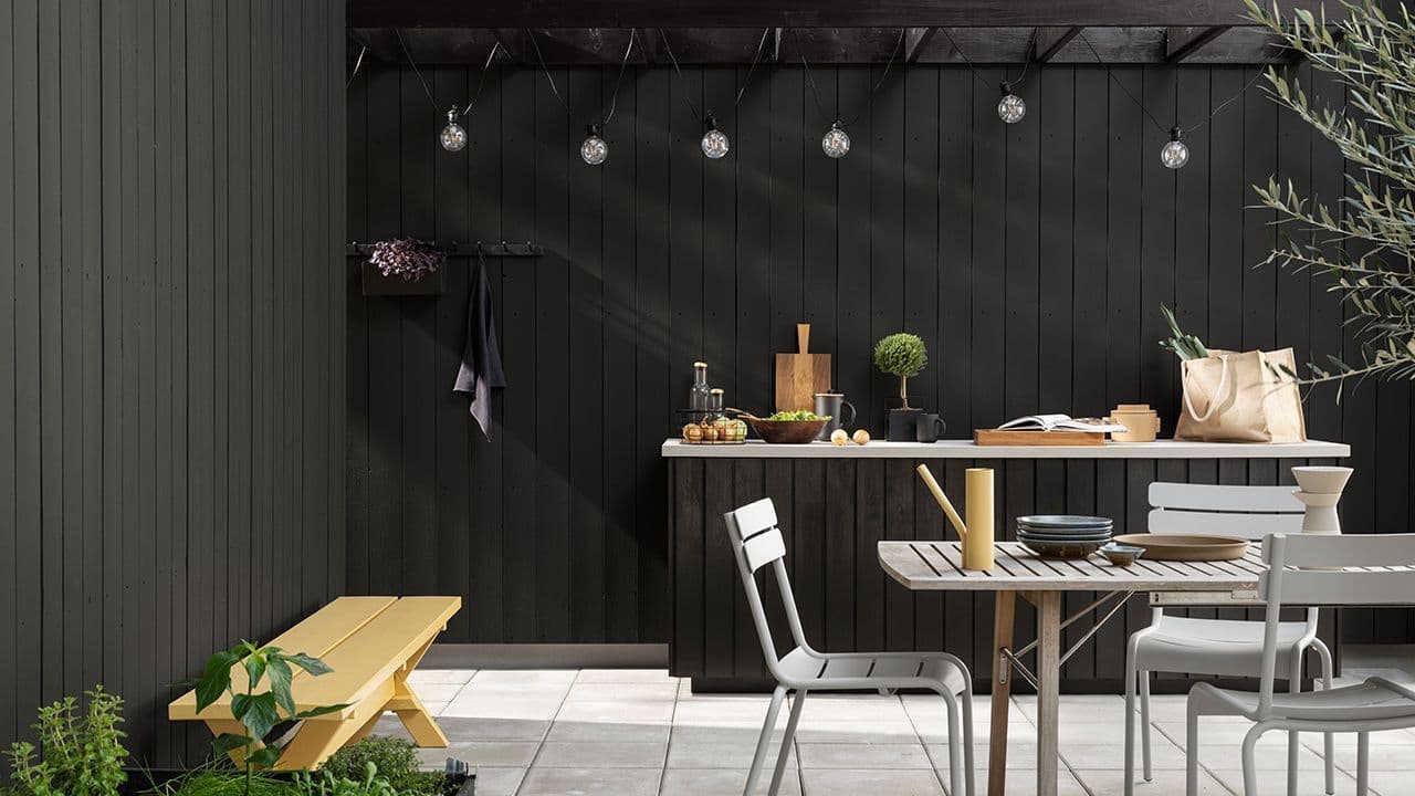 Fasade, utekjøkken og pergola malt med matt svart maling fra Jotun i fargene 1434 Labrador, 0737 Brunsvart og Trebitt 9805 Sløret Sort.